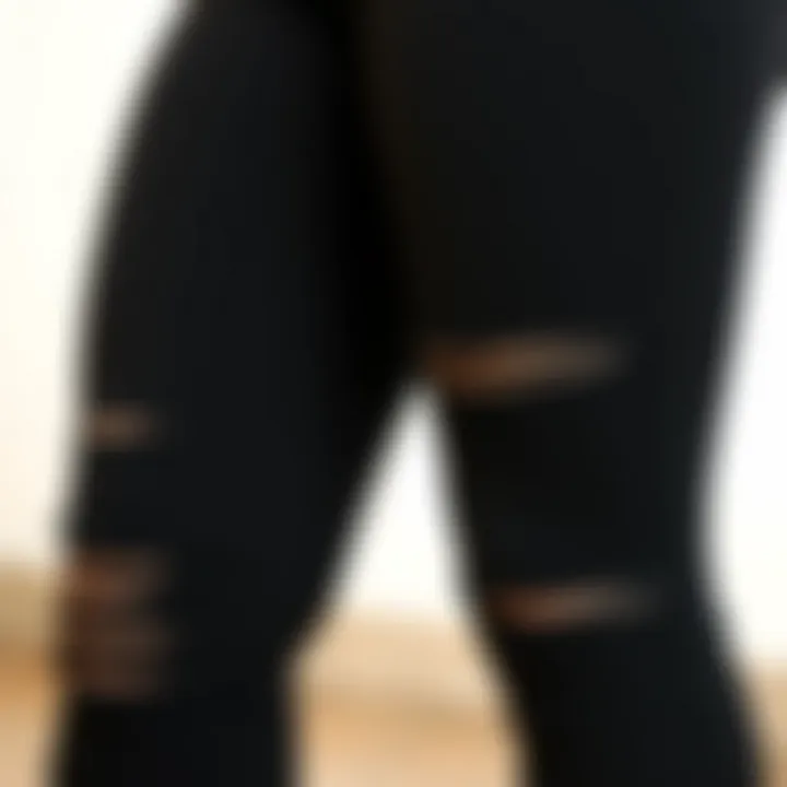 Close-up of the fabric texture of plus size black distressed leggings.