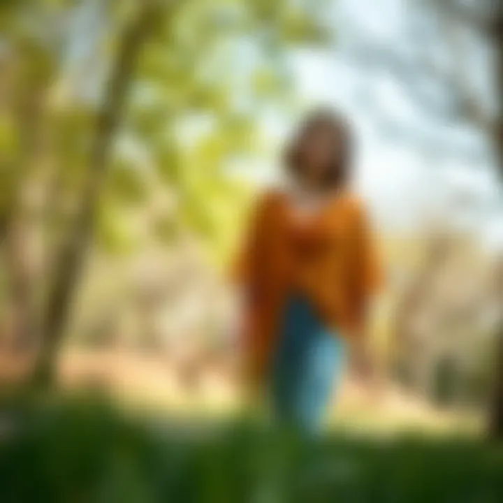 Stylish layering of chiffon poncho over casual outfit in a park setting