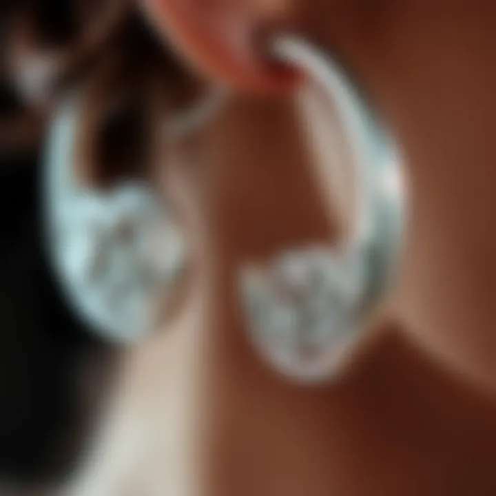 Close-up of intricate design details in silver hoop earrings